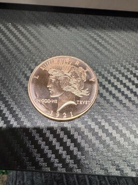 One oz copper Peace Dollar Proof round.